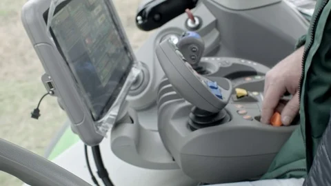 Tractor operator drives modern tractor Stock Footage 70081840