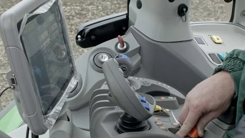 Tractor operator drives modern tractor Stock Footage 70082532