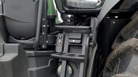 Tractor operator presses button to open modern tractor's hood Stock Footage 70082177