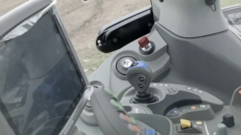 Tractor operator starts modern tractor engine inside cabin Stock Footage 70081794