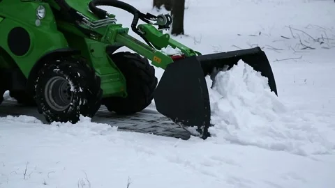 Tractor in the park cleans the snow Stock Footage 86163628