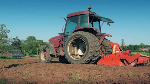 Tractor Passes In Field On Sunny Day Stock Footage 335312976