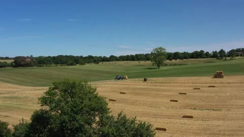 Tractor piling round baller Stock Footage 144541375