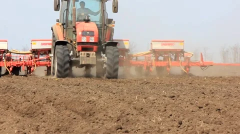 Tractor with planter approaches by a field Stock Footage 62374394