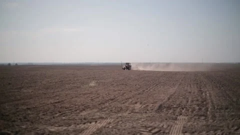 Tractor with a planter in the field sowing corn. Agriculture and agronomy on an  Stock Footage 223525934