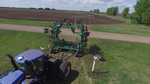 Tractor with planter sows boundless field clouseup Stock-Footage 78155890