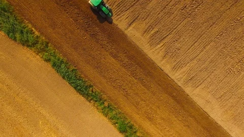 Tractor with plough working on a field. Stock Footage 95757533