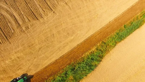 Tractor with plough working on a field. Stock Footage 95758080