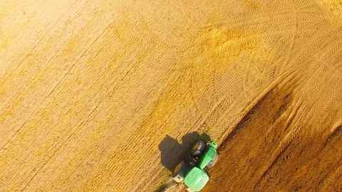Tractor with plough working on a field. Stock Footage 95758426