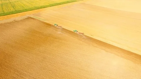 Tractor with plough working on a field. Stock Footage 95759112