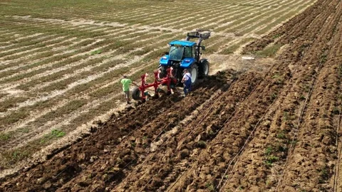 Tractor with plough working on a field. Stock Footage 139394087
