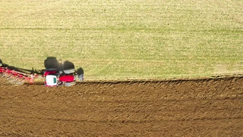 Tractor with plough working on a field. Stock-Footage 159437441