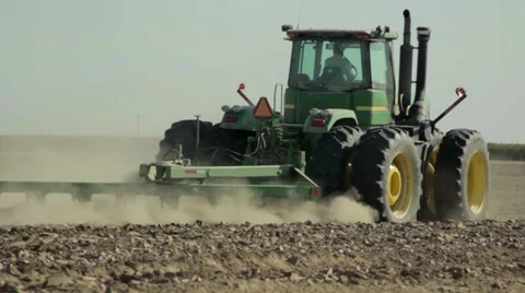 Tractor ploughing field on farm. Stock Footage