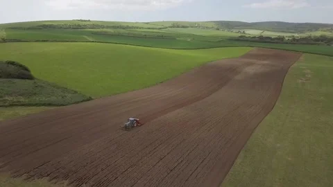 Tractor ploughing fields in England Stock Footage 199424491