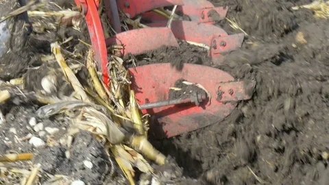 Tractor ploughing ground of agro field at spring Stock Footage 75440950