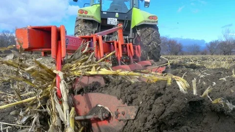 Tractor ploughing ground of agro field at spring Stock Footage 75443395