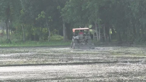 A tractor is ploughing the muddy field Stock Footage 314513663