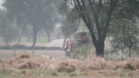 Tractor ploughing a wheat field Video stock 90679660