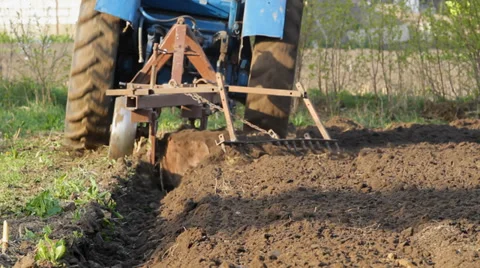 Tractor ploughs up earth in the field Stock Footage 36594292