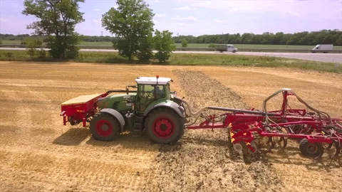 Tractor plow the field, seeding, sowing agricultural crops at field Stock Footage 111000467