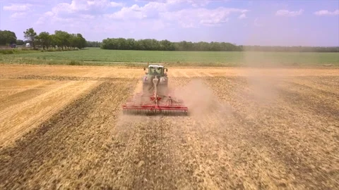 Tractor plow the field, seeding, sowing agricultural crops at field Stock Footage 113708085
