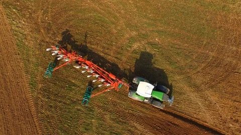 Tractor with a plow on a field in spring in germany - aerial view Stock Footage 88493301
