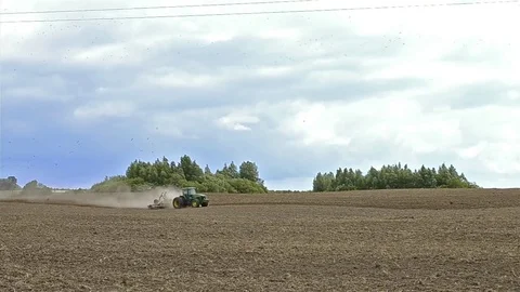 Tractor with plow plowing field after harvest Video stock 78990485