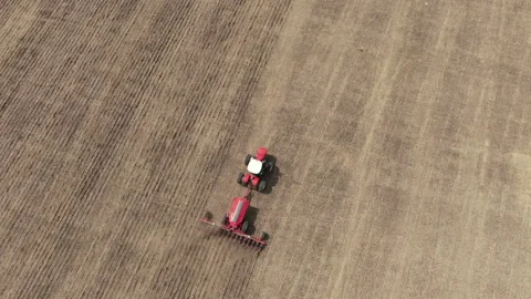 Tractor with a plow plowing the ground Stock Footage 235616338