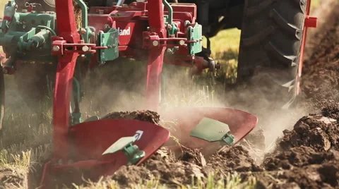 Tractor with plow plowing the land Video stock 56684251