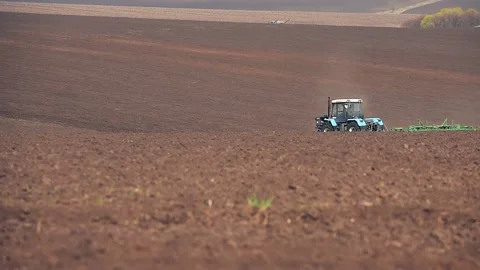 A tractor plowing and sowing in the field. Panoramic format Stock Footage 149100910