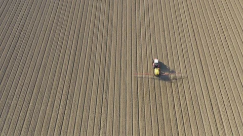 Tractor plowing and spraying on field. Stock Footage 118798076
