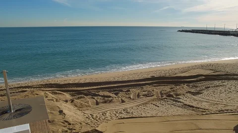 A Tractor plowing the beach. The operator levels Sand and redistributes it Stock Footage 102160065