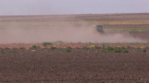 Tractor plowing in blowing dust 1 Stock Footage 27469295