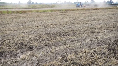 Tractor plowing dry paddy field Stock Footage 47235899