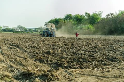Tractor plowing in dusk Stock Photos