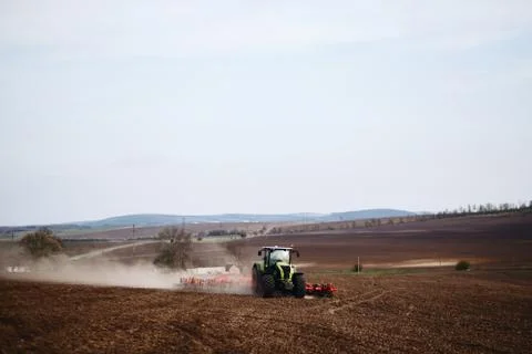 Tractor plowing the earth, black earth Stock Photos