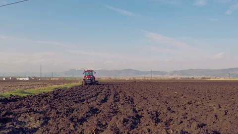 Tractor plowing the field 4K Stock Footage 127977141