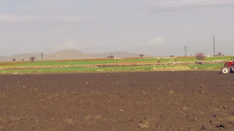 Tractor plowing the field 4K Stock Footage 127977907