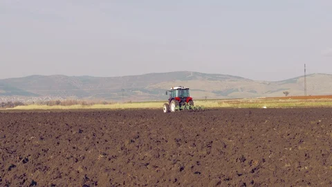Tractor plowing the field 4K Stock Footage 127978883