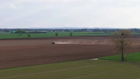 Tractor Plowing Field from Aerial View Stock Footage 273893907