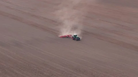 Tractor Plowing Field from Aerial View Stock Footage 273894295