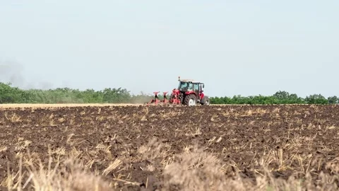 Tractor plowing field after wheat crop Stock Footage 157574141