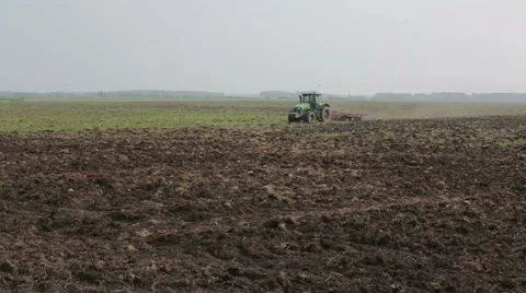 Tractor plowing field, agriculture Stock Footage 65370853