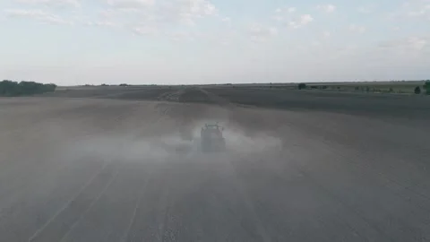 Tractor Plowing Field In A Cloud Of Dirt Slow Motion Aerial Shot Stock Footage 316713305