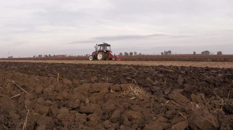 Tractor plowing field on cloudy fall day. Aerial footage. Stock Footage 57368736