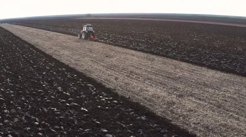 Tractor plowing field on cloudy fall day. Aerial footage. Stock Footage 57370108