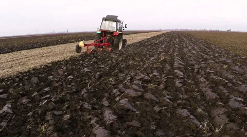 Tractor plowing field on cloudy fall day. Aerial footage. Stock Footage 57370519