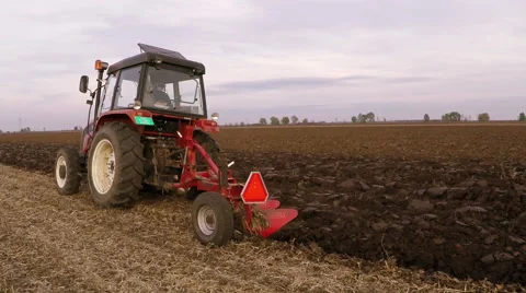 Tractor plowing field on cloudy fall day. Aerial footage. Stock Footage 57370626