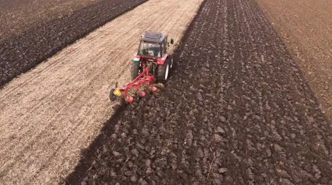 Tractor plowing field on cloudy fall day. Aerial footage. Stock Footage 57374019