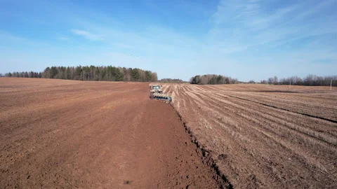 Tractor plowing field, drone view. Cultivated land and soil tillage. Видео 191675709